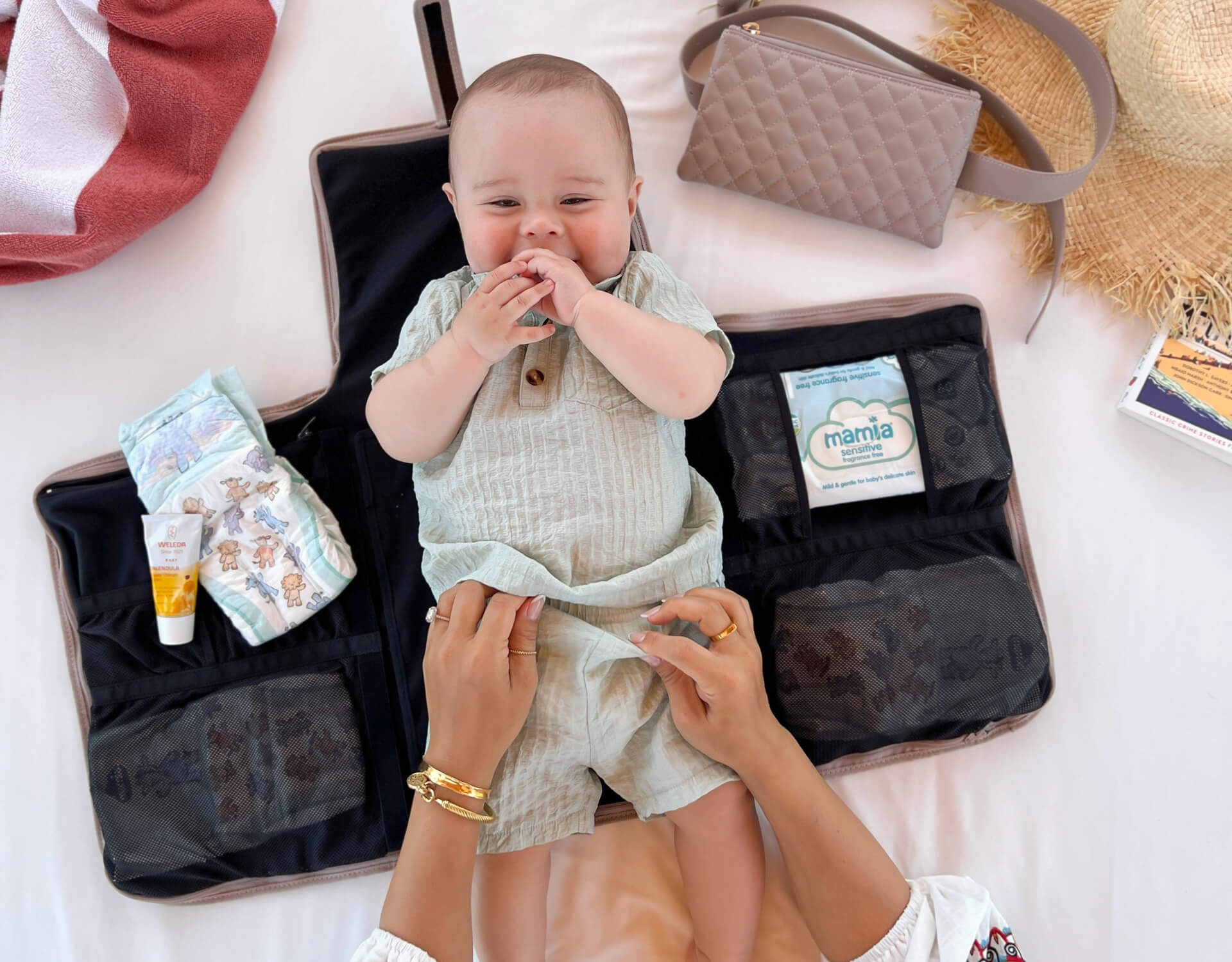 Baby laying on a Coco Alexander changing bag